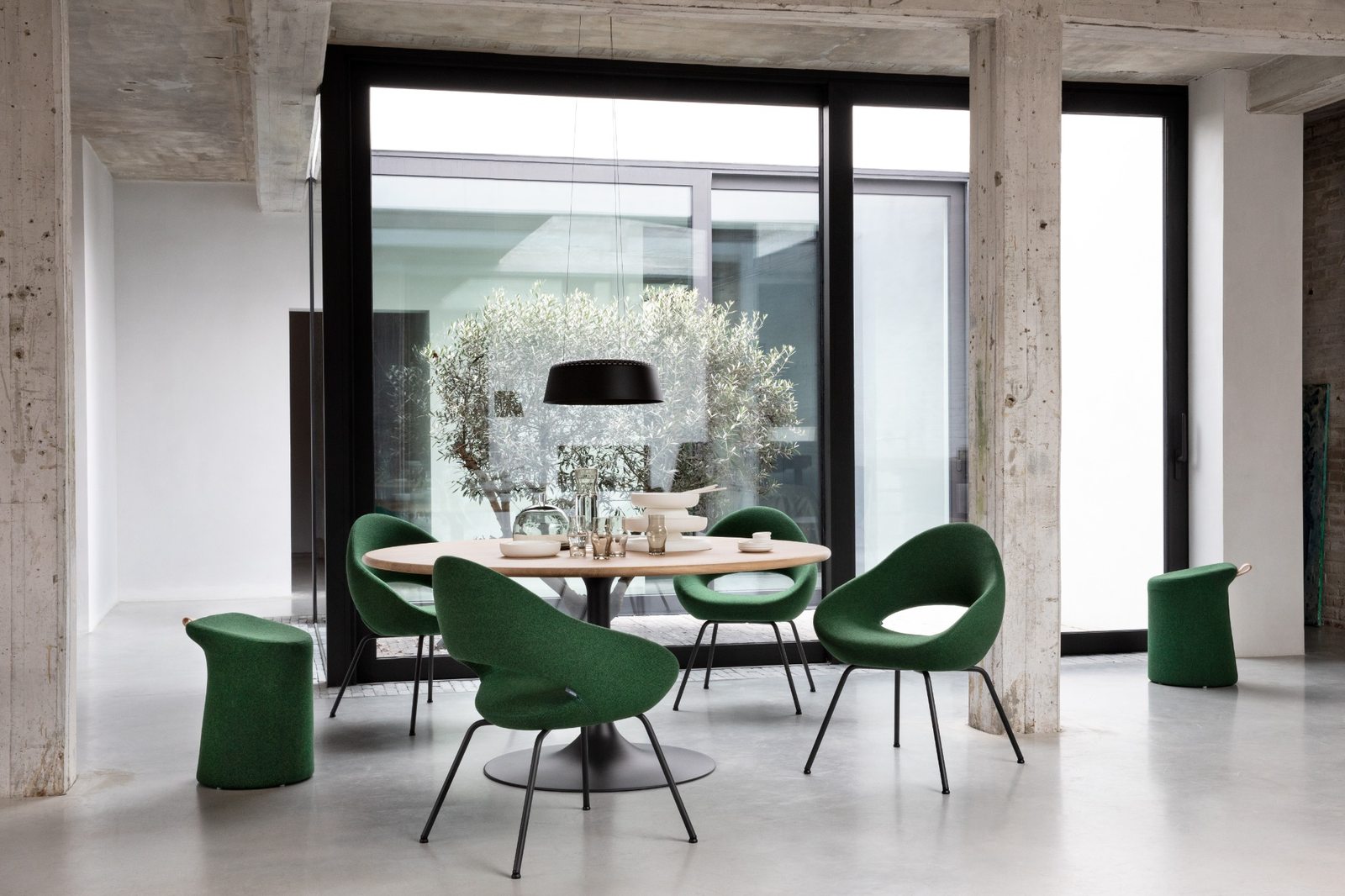 Groene Artifort Shark eetkamerstoelen rondom een ronde houten tafel